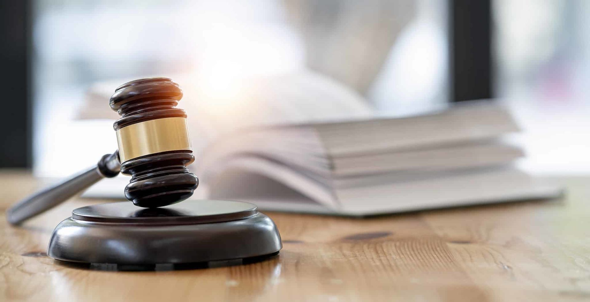 Wooden Brown Judge Gavel On The Table, Copy Space, Banner Background. Wooden brown judge gavel on the table, copy space, banner background.